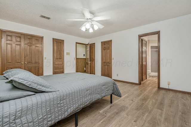 613 Bennett Dr, Dumas, TX 79029 - bedroom with light wood-style flooring, baseboards, ceiling fan, a textured ceiling, and connected bathroom