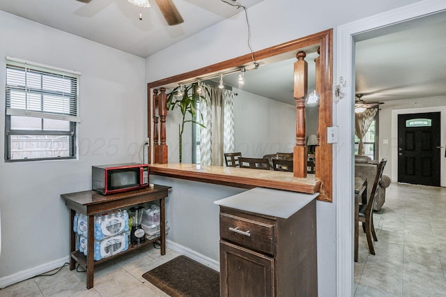 126 S Nelson St, Pampa, TX 79065 - kitchen with ceiling fan, baseboards, and dark brown cabinetry