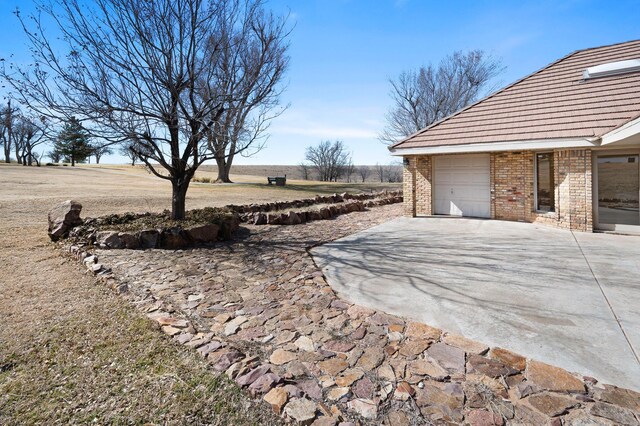 exterior space with driveway and an attached garage