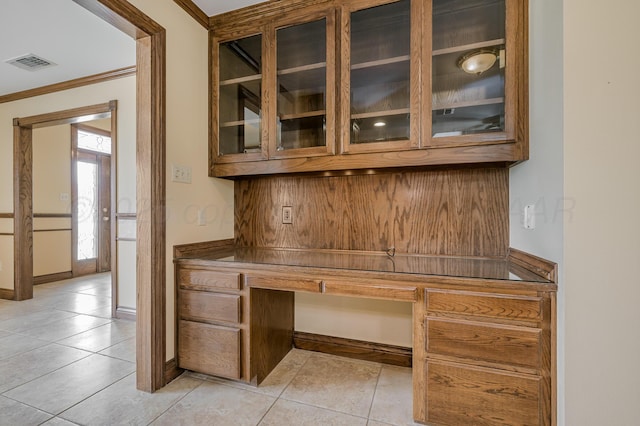 unfurnished office featuring light tile patterned floors, baseboards, and visible vents