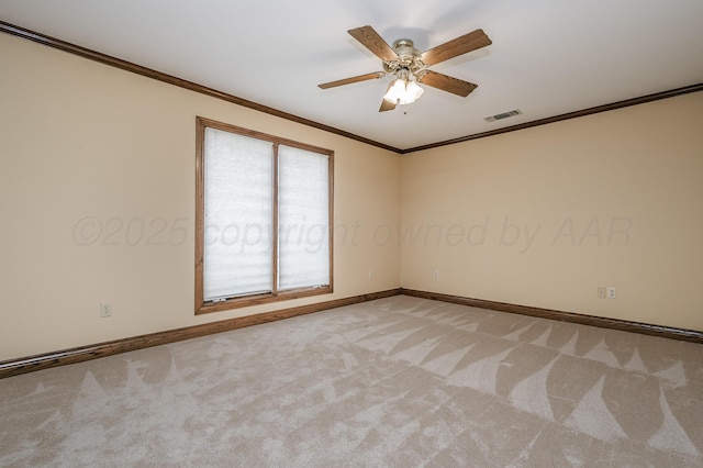 spare room featuring crown molding, visible vents, a ceiling fan, light carpet, and baseboards