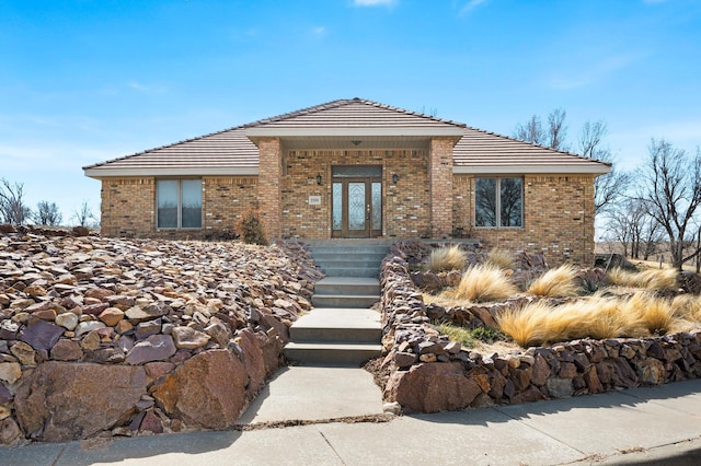 view of front of house featuring french doors and brick siding