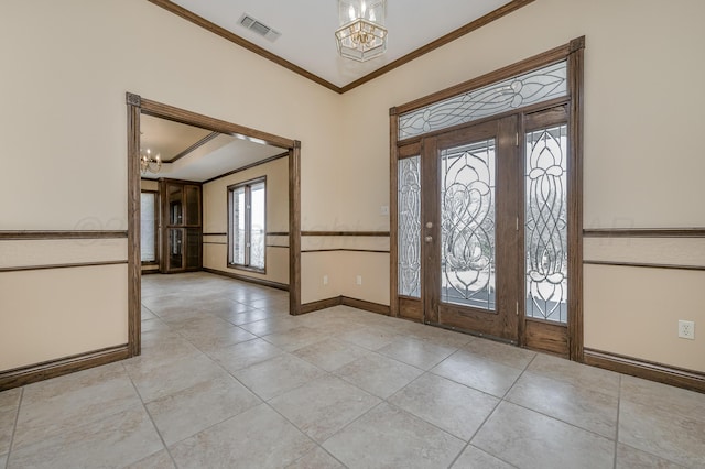 foyer with baseboards, visible vents, ornamental molding, and a notable chandelier