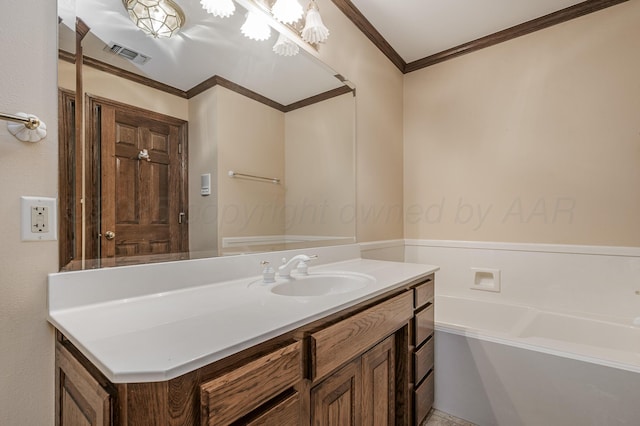 bathroom with visible vents, crown molding, and vanity