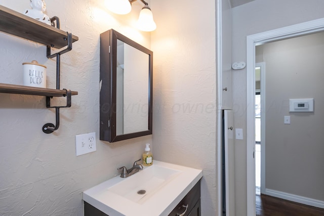 1910 S Seminole St, Amarillo, TX 79103 - bathroom featuring vanity and wood finished floors