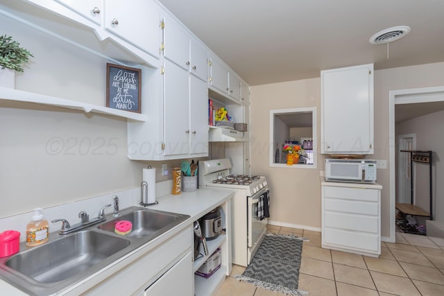 1910 S Seminole St, Amarillo, TX 79103 - kitchen featuring white appliances, open shelves, light tile patterned floors, white cabinets, and light countertops