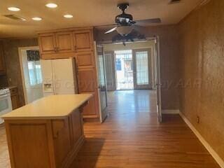 2237 Locust St, Amarillo, TX 79109 - kitchen featuring white refrigerator with ice dispenser, light wood-type flooring, recessed lighting, a ceiling fan, and baseboards
