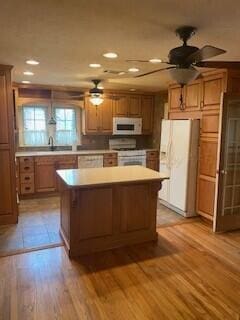 2237 Locust St, Amarillo, TX 79109 - kitchen featuring white appliances, a ceiling fan, a kitchen island, light countertops, and recessed lighting