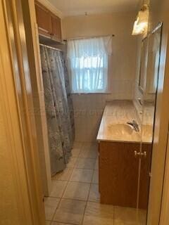 2237 Locust St, Amarillo, TX 79109 - full bathroom with vanity, tile patterned floors, and a shower with shower curtain