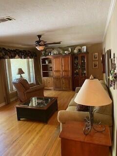 2237 Locust St, Amarillo, TX 79109 - living area with ornamental molding, ceiling fan, and light wood-type flooring