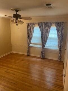 2237 Locust St, Amarillo, TX 79109 - unfurnished room featuring baseboards, wood finished floors, and ceiling fan