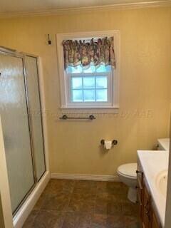 2237 Locust St, Amarillo, TX 79109 - full bathroom with vanity, toilet, a stall shower, baseboards, and crown molding