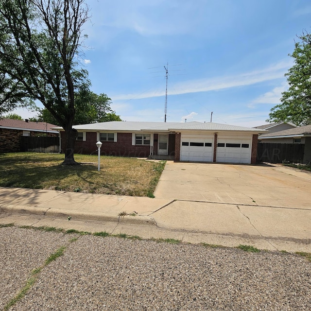 ranch-style house with a garage and a front yard