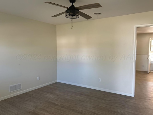 empty room featuring ceiling fan and dark hardwood / wood-style floors