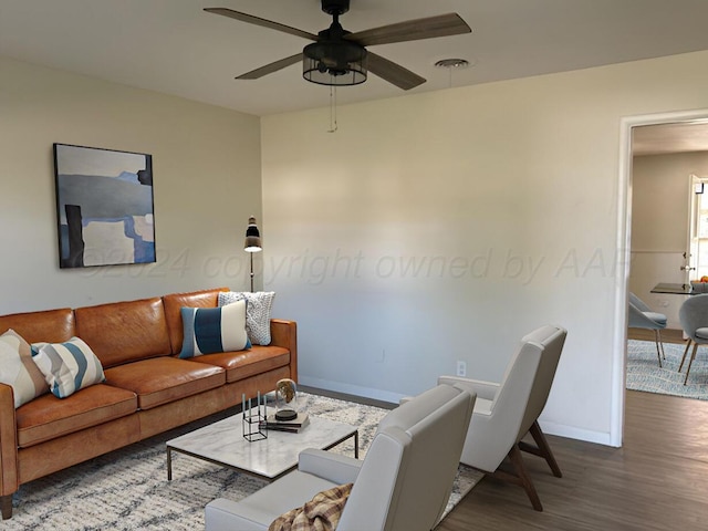 living room with ceiling fan and dark wood-type flooring