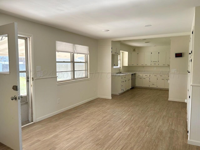 1610 Jordan St, Amarillo, TX 79106 - kitchen with dishwasher, light wood-style floors, white cabinetry, and light countertops