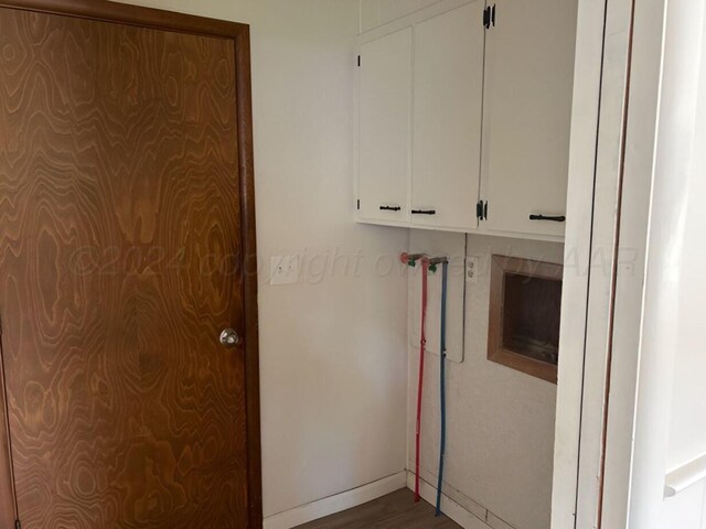 1610 Jordan St, Amarillo, TX 79106 - laundry room featuring dark wood finished floors and cabinet space