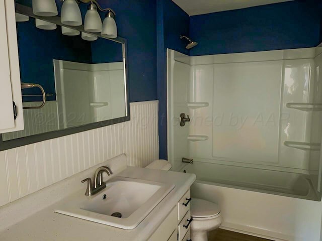 full bathroom with shower / tub combination, vanity, and toilet