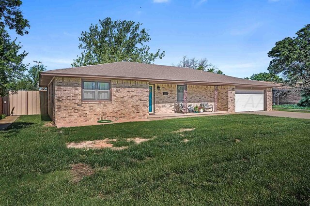 15 Fannin Dr, Tulia, TX 79088 - ranch-style home featuring brick siding, concrete driveway, and a garage