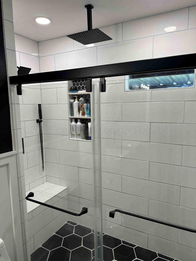 15 Fannin Dr, Tulia, TX 79088 - full bath featuring a shower stall and tile patterned floors