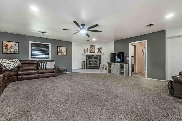 15 Fannin Dr, Tulia, TX 79088 - living room with carpet, a ceiling fan, a glass covered fireplace, and recessed lighting