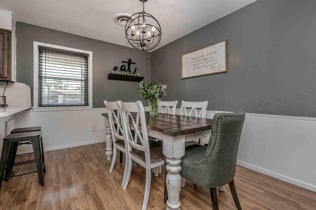 15 Fannin Dr, Tulia, TX 79088 - dining room featuring a chandelier, wood finished floors, and baseboards