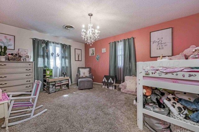 15 Fannin Dr, Tulia, TX 79088 - bedroom featuring a chandelier, carpet flooring, and a textured ceiling