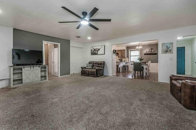 15 Fannin Dr, Tulia, TX 79088 - carpeted living room featuring a chandelier and ceiling fan