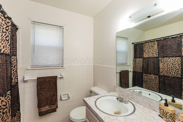 707 N Arkansas St, Shamrock, TX 79079 - full bathroom with vanity, tile walls, wainscoting, and curtained shower