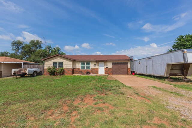 707 N Arkansas St, Shamrock, TX 79079 - ranch-style home with an attached garage, brick siding, a front lawn, and driveway