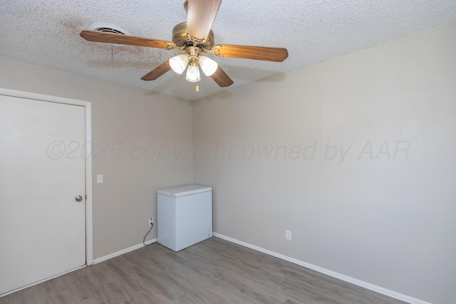 707 N Arkansas St, Shamrock, TX 79079 - empty room featuring wood finished floors, a textured ceiling, and ceiling fan