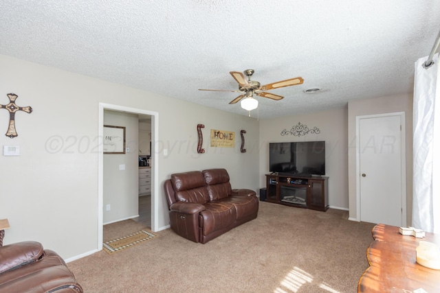 707 N Arkansas St, Shamrock, TX 79079 - living room with a ceiling fan, light carpet, and a textured ceiling