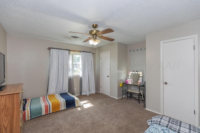 707 N Arkansas St, Shamrock, TX 79079 - bedroom with a textured ceiling, carpet flooring, and a ceiling fan