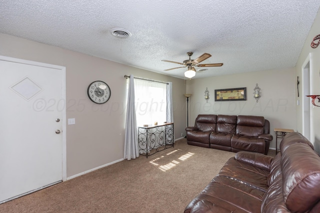 707 N Arkansas St, Shamrock, TX 79079 - living room with carpet floors, a ceiling fan, and a textured ceiling