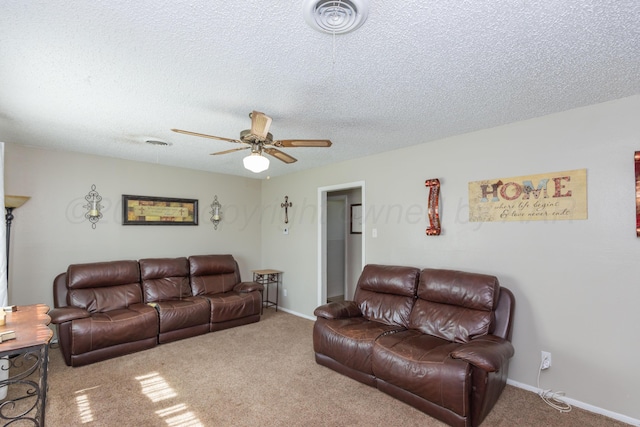 707 N Arkansas St, Shamrock, TX 79079 - carpeted living area featuring a ceiling fan and a textured ceiling