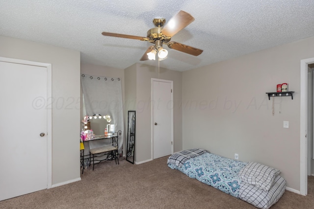 707 N Arkansas St, Shamrock, TX 79079 - bedroom featuring carpet, a textured ceiling, and ceiling fan