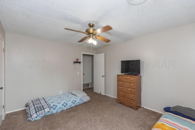 707 N Arkansas St, Shamrock, TX 79079 - carpeted bedroom featuring ceiling fan and a textured ceiling