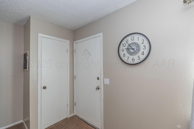 707 N Arkansas St, Shamrock, TX 79079 - entryway with carpet floors and a textured ceiling