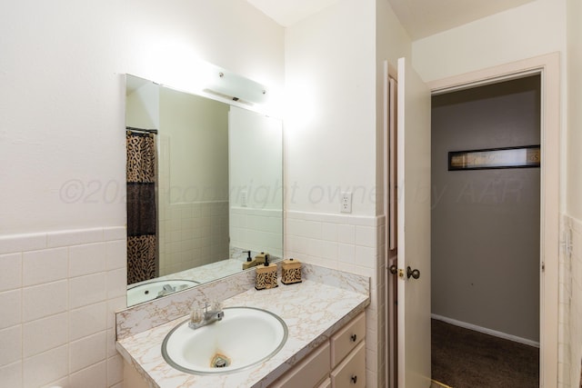 707 N Arkansas St, Shamrock, TX 79079 - full bathroom featuring vanity, tile walls, and a wainscoted wall