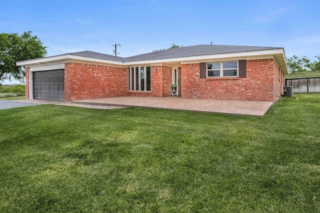 5800 Hester Rd, Amarillo, TX 79124 - view of front facade with central AC, an attached garage, brick siding, driveway, and a patio area