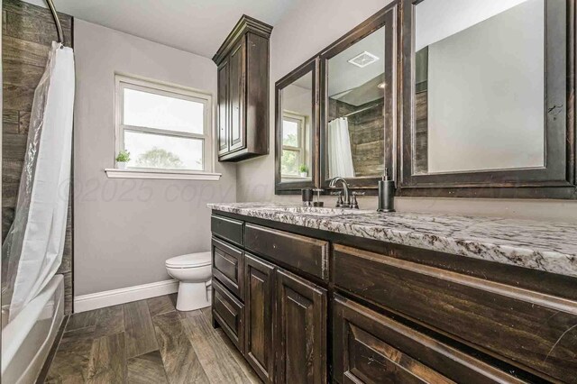 5800 Hester Rd, Amarillo, TX 79124 - full bath with vanity, toilet, baseboards, and shower / tub combo