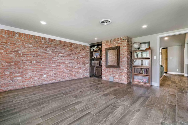 5800 Hester Rd, Amarillo, TX 79124 - unfurnished living room with brick wall, wood finished floors, and recessed lighting