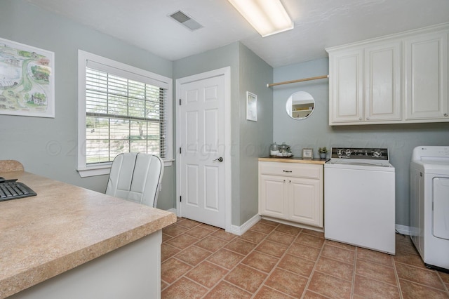 laundry area with washing machine and clothes dryer, baseboards, visible vents, and cabinet space