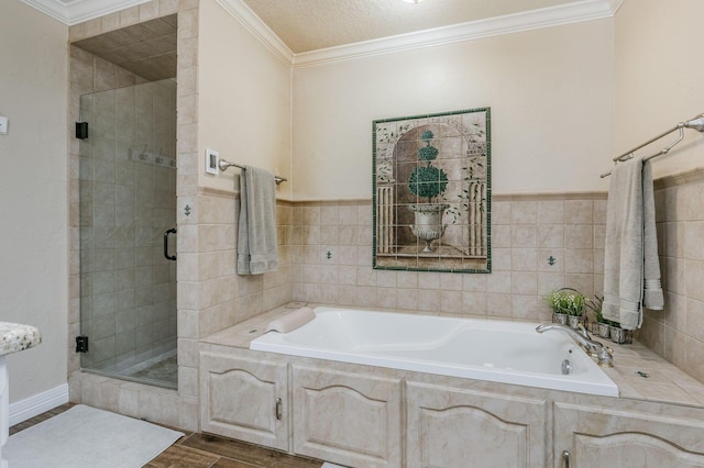 full bath featuring a garden tub, ornamental molding, a shower stall, and wood finished floors