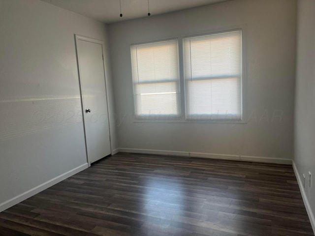 empty room featuring dark hardwood / wood-style floors and a wealth of natural light