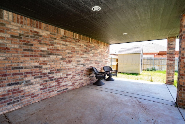 9909 Asher Ave, Amarillo, TX 79119 - view of patio featuring a shed, fence, and an outdoor structure