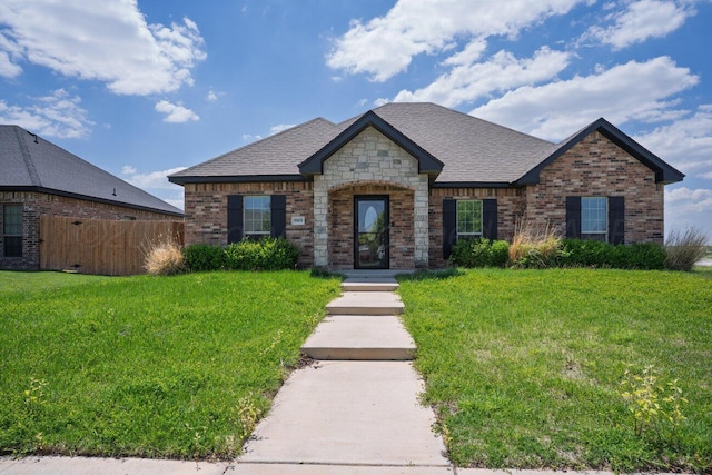 9909 Asher Ave, Amarillo, TX 79119 - french country home with brick siding and roof with shingles