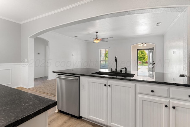 9909 Asher Ave, Amarillo, TX 79119 - kitchen with stainless steel dishwasher, a sink, light wood finished floors, arched walkways, and crown molding