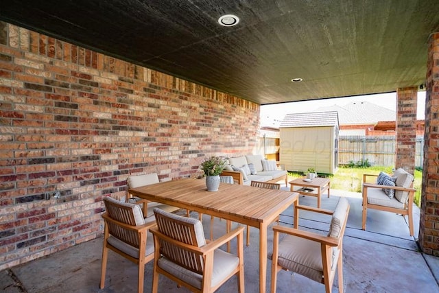 9909 Asher Ave, Amarillo, TX 79119 - view of patio with an outdoor living space, fence, a storage shed, and an outdoor structure