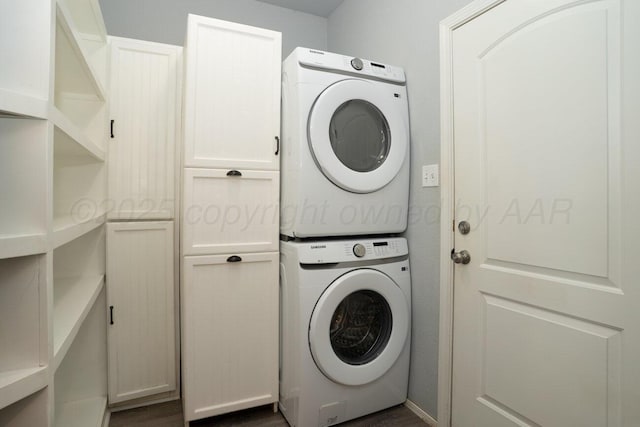 9909 Asher Ave, Amarillo, TX 79119 - laundry area featuring stacked washing machine and dryer and cabinet space